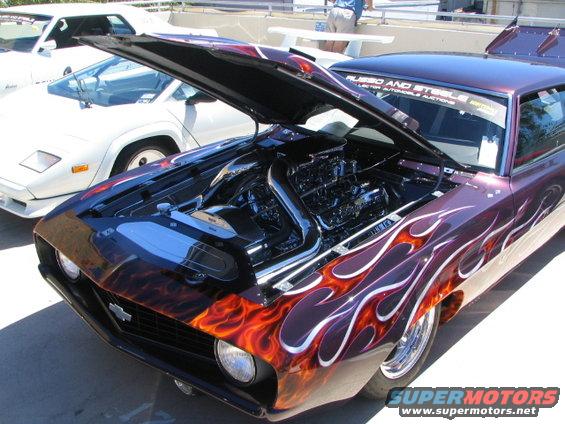 Purple 1969 Chevrolet Camaro with flame decals and chrome engine