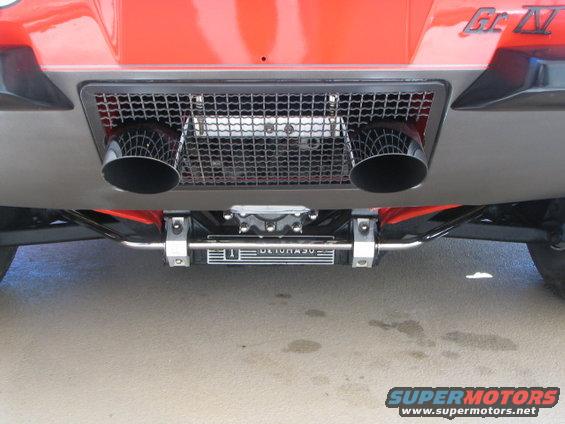 Dual exhaust pipes exiting through a rear grille, with 'ULTRA 50' visible on a component below