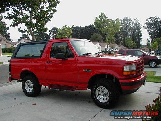 Red 1995 Ford Bronco side view with black top