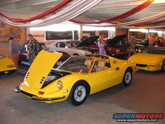 Yellow sports car with hood open, interior visible