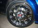 1993 Ford Taurus - Close-up of a shiny chrome wheel on a blue vehicle.