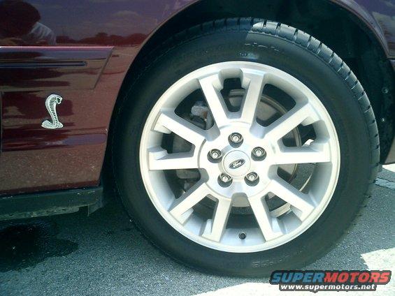 Maroon 2004 Ford Crown Victoria side view showing a cobra emblem on the fender