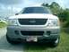 2002 Ford Explorer - The front grille and headlights of a 2002 Ford Explorer are visible, along with a decorative license plate.