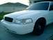 2000 Ford Crown Victoria - front drivers side 3/4 view, with the honeycomb grille painted white on the edges.