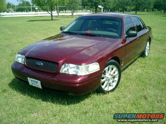 Maroon 2004 Ford Crown Victoria parked on grass