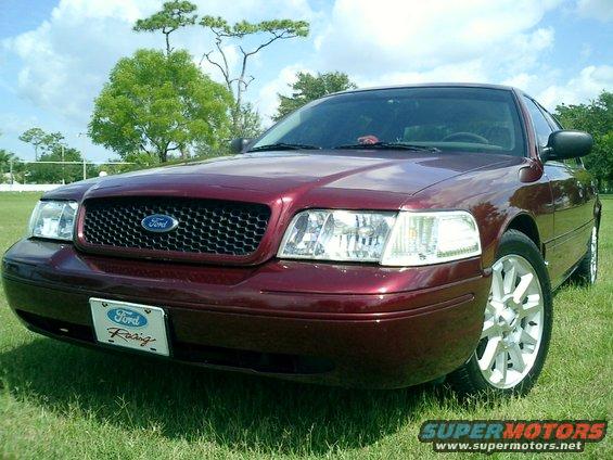 Red 2004 Ford Crown Victoria front view with custom wheels and Ford Racing plate