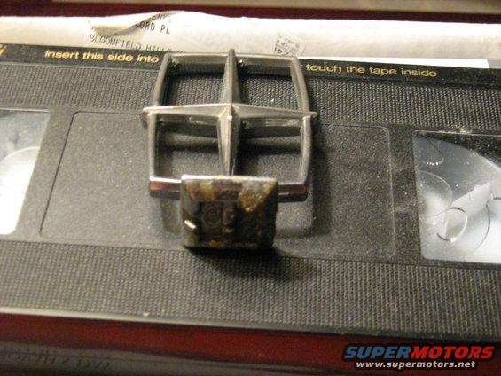 Car emblem sitting on top of a VHS tape