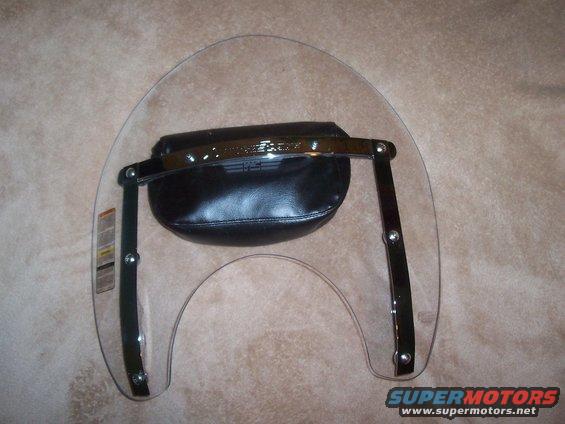Motorcycle windshield with a black leather bag attached to the chrome support bars