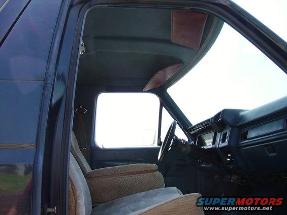 1980 Ford Bronco interior with cloth seats, armrest, dashboard, and steering wheel