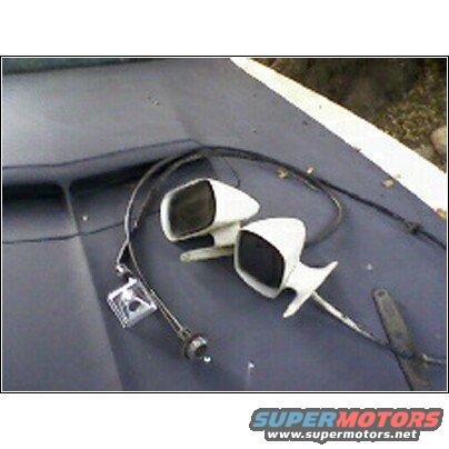 Pair of white side mirrors and antenna base on a dark surface, possibly a car hood