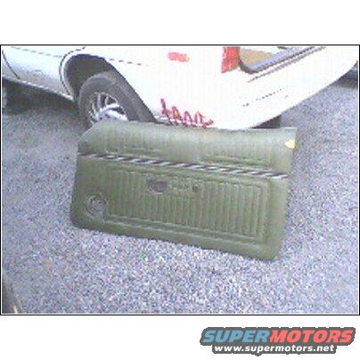 Green door panel with horizontal trim, resting in front of a white vehicle
