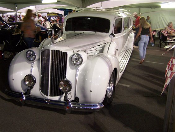 White limousine with a tall grille and dual headlights parked outdoors