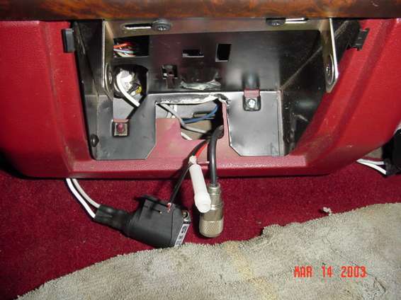 cb_move_31403_002.jpg This is where the pics start, sorry, didnt have the memory stick in the camera...Duh...See how I had to cut a notch in the ashtray mount thingie to let the CB cable go out the back. It also shows the mount bracket, and the new power port that I put in because I am loosing the cigarette lighter port.