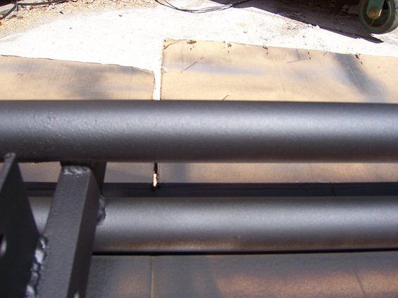 Black fabricated steel bumper with visible welds and mounting brackets