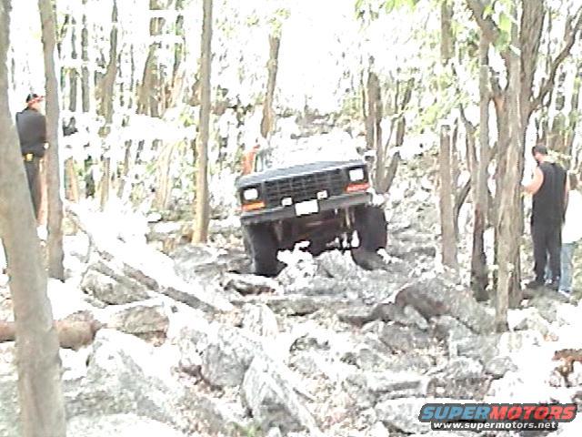 1978 Ford Bronco navigating a rocky, wooded trail
