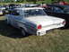 1964 Ford Fairlane - A white 1963 Ford Falcon is parked on a grassy field at an outdoor car show.