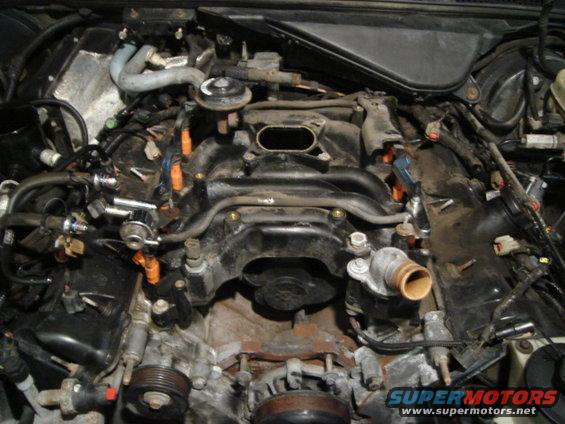 Engine bay with intake manifold removed, showing fuel injectors and wiring
