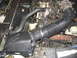 2000 Ford Crown Victoria - Close-up view of a vehicle's engine bay, focusing on the air intake and associated components.