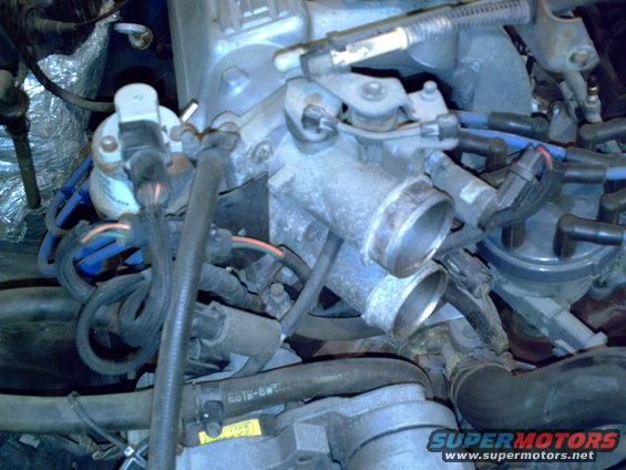 Engine throttle body with hoses and wiring