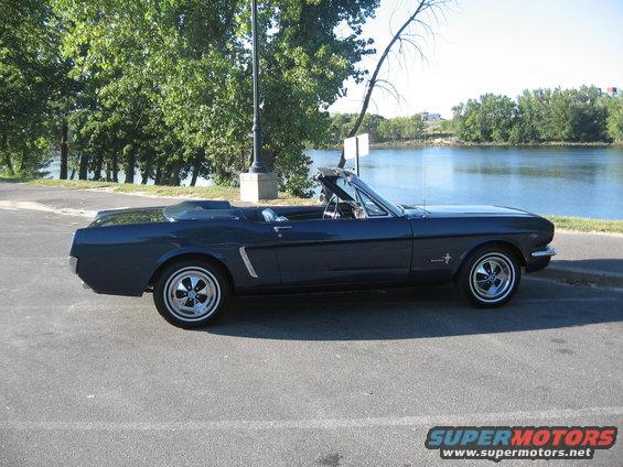 1965 Ford Mustang convertible, dark blue, parked roadside near water