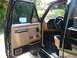 1987 Ford F-150 - The driver's side door is open, revealing the tan interior of a 1987 Ford F-150 pickup truck.