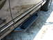 1987 Ford F-150 - Close-up of a black truck's side step, the LUND brand name.