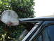 1987 Ford F-150 - Close-up of a black vehicle's visor and roofline, with a basketball hoop visible.