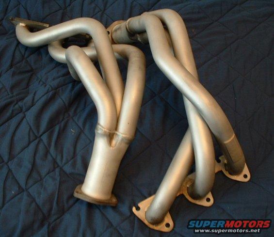 exhaust headers on a blue quilted surface