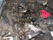 1987 Lincoln Town Car - A cluttered engine bay with numerous hoses and electrical wiring visible, suggesting a complex mechanical system.