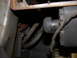 1987 Lincoln Town Car - Close-up view of engine bay components, including hoses and belts, with visible rust on a metal bracket.