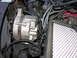 1987 Lincoln Town Car - Close-up view of engine components, focusing on the alternator and associated wiring.