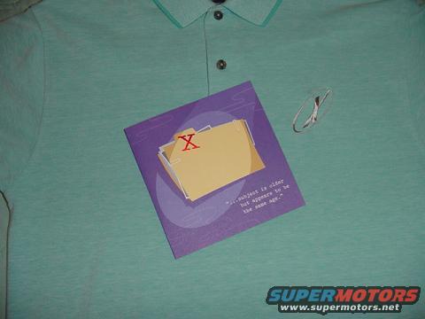 Teal polo shirt with a purple tag showing a file folder and text. A silver 'X' logo is on the shirt