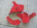 1986 Ford Bronco - Several red painted metal brackets are laid out on a concrete floor.