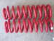 1986 Ford Bronco - A pair of red coil springs are shown against a textured background.