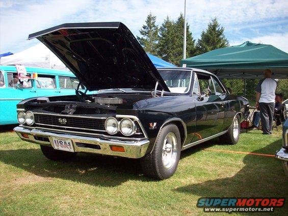 1966 Chevrolet Chevelle SS with hood open, parked on grass