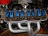 engine intake manifold with blue components and exhaust headers