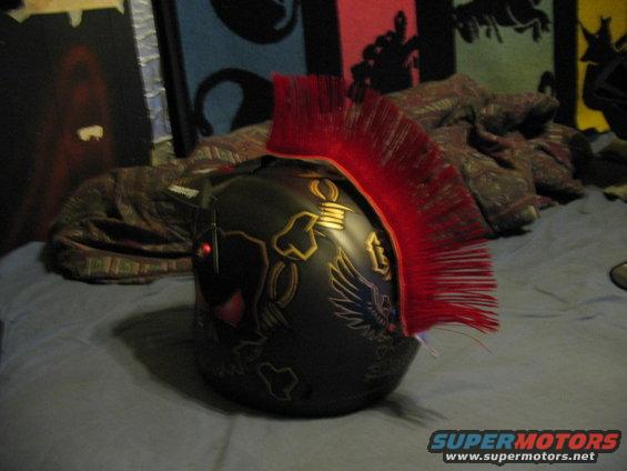 Black helmet with red mohawk and gold graphics, side view