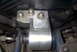 1994 Dodge Stealth - This is a close-up view of an aftermarket motor mount, likely made of aluminum, with visible bolts and a textured surface.