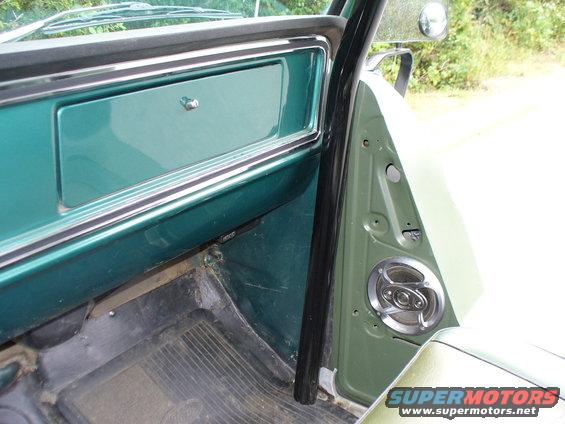 Green interior door panel and dashboard with chrome trim and speaker