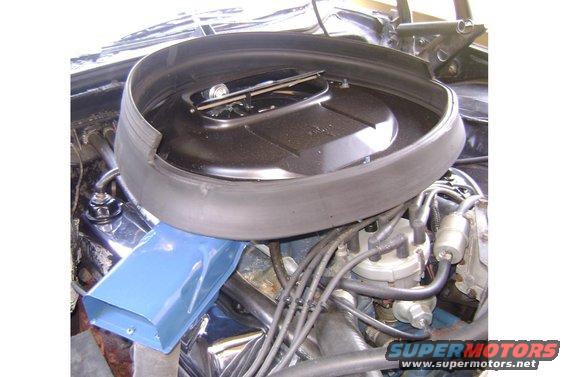 Close-up of engine bay showing air cleaner assembly and distributor