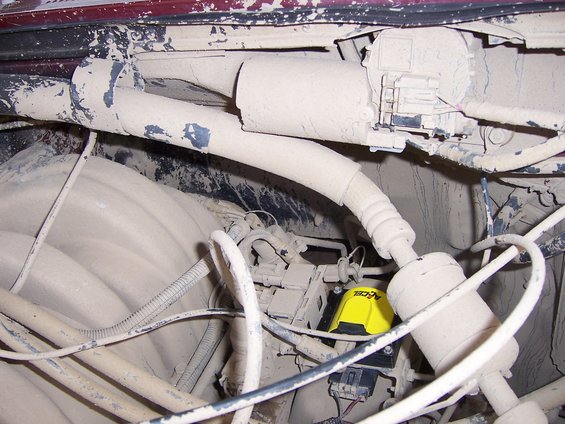 Dust-covered engine bay with yellow ACCEL ignition component