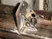 1989 Ford Bronco - Close-up of a custom-fabricated metal bracket, welded onto a steel tube, possibly for a rear bumper assembly.