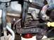 2003 Ford Ranger - Close-up view of spark plugs and exhaust manifold components within an engine bay.