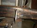 1989 Ford Bronco - Close-up of metal fabrication and welding on a rusty steel structure in a workshop setting.