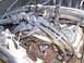 2003 Ford Ranger - Close-up view of a Ford V8 engine, showing spark plug wires and exhaust manifold.