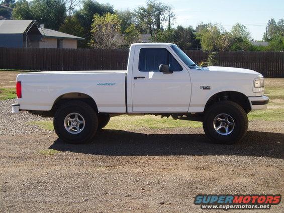 White 1994 Ford F-150 pickup truck parked on gravel