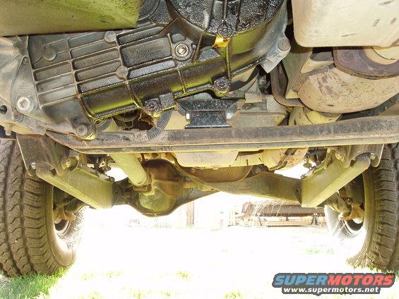 Underside view of a vehicle showing the transmission, driveshaft, and rear axle assembly