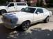 1978 Ford Mustang II - This white coupe, likely a 1975 model, is parked in a driveway next to a pickup truck.