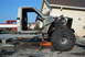 1982 Toyota 4Runner - A disassembled pickup truck chassis is shown with its engine exposed, while another truck sits in the background.
