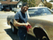 1978 Ford Ranchero - A man stands next to a gold pickup truck, holding a red rag.